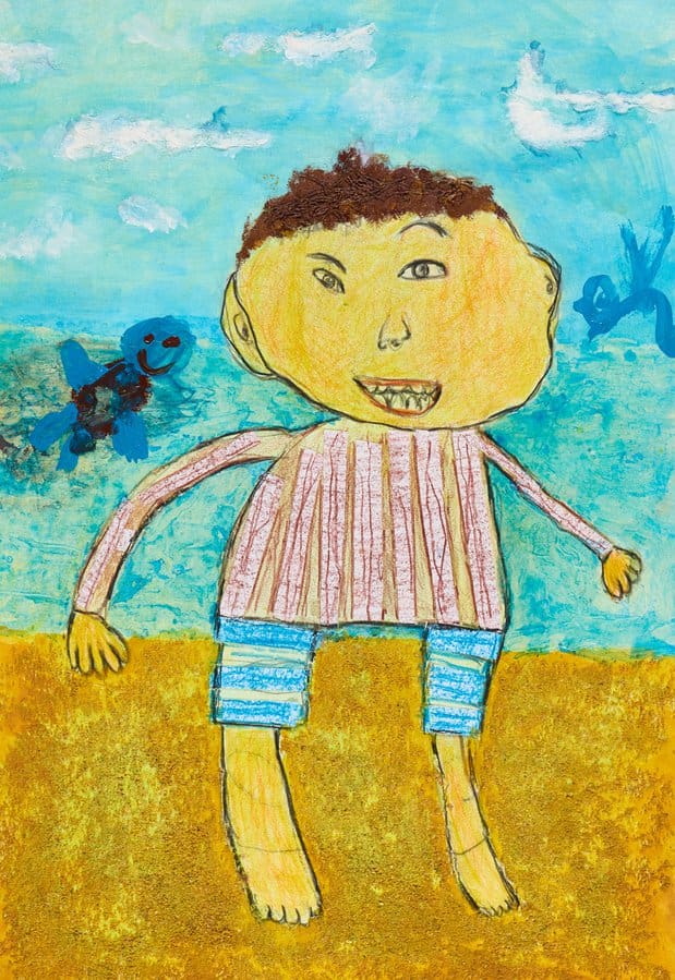 drawing of boy on sand at beach
